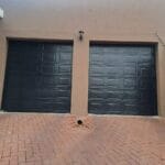Two aluzinc charcoal single caravan garage doors exterior view
