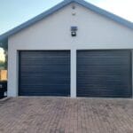 Two aluzinc charcoal slatted single garage doors modern exterior