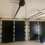 Interior view of two black aluminium single garage doors with track system