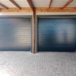 Two charcoal aluminium single garage doors installed side by side on exterior