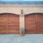 Custom meranti wooden double garage doors with decorative hardware