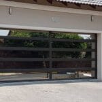 Black aluminium and glass sectional garage door with horizontal panels