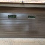 Aluminium garage door with four horizontal glass inserts