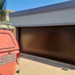 Exterior bronze narrow fluted aluminium double garage door on residential property