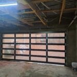 Frameless bronze glass double garage door interior view