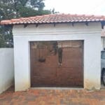 Frameless bronze glass single garage door exterior view