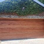 Exterior horizontal slatted meranti garage door modern home