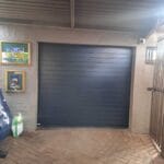 Dark charcoal aluminium garage door with horizontal panel design