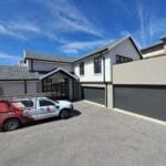 Modern home with single and double frameless aluminium cladded garage doors