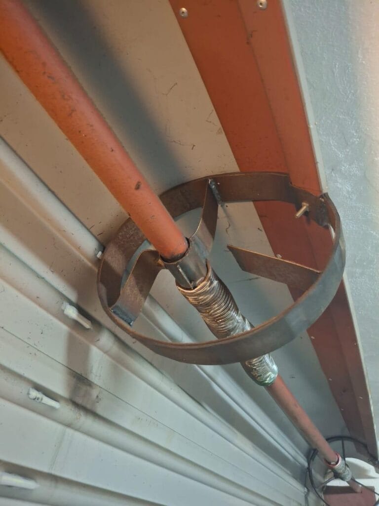 Garage door torsion spring system with safety bracket and shaft installation