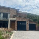 Charcoal fluted aluminium garage door with horizontal window inserts
