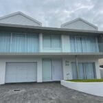 Minimalist white cladded aluminium garage door with seamless panel finish