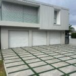 Minimalist white cladded aluminium garage door with seamless panel finish