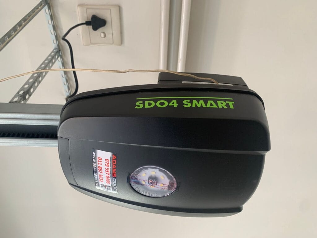 Centurion SD04 Smart garage door opener mounted on sectional garage door rail
