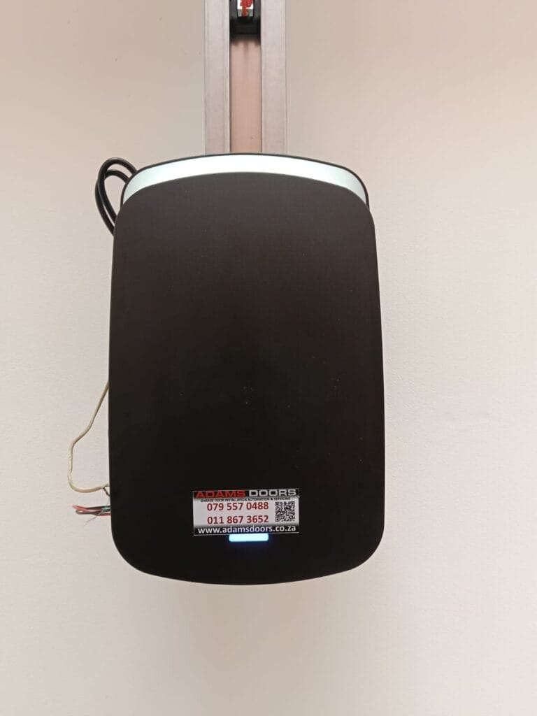 Magiclift automatic garage door motor mounted on sectional garage door track